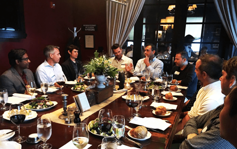 men sitting around dining table at formal restaurant